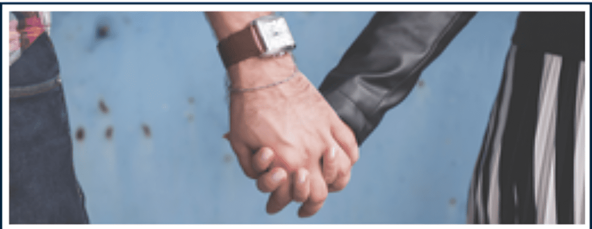 Two people holding hands with a watch on the wrist.