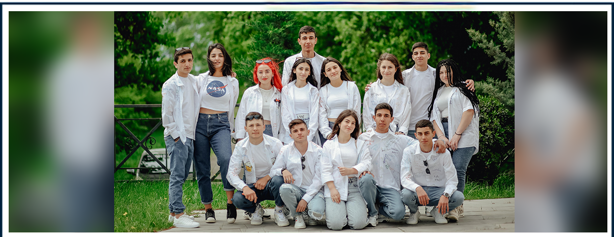 A group of people in white shirts and jeans.